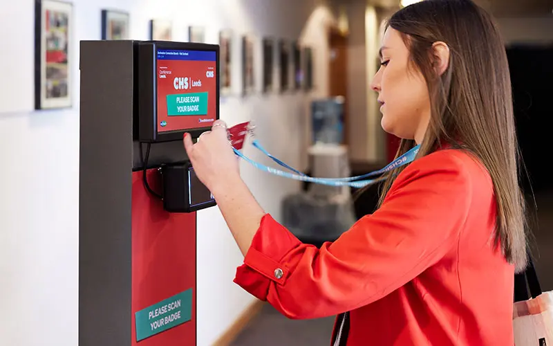 Person scanning a badge at a ScanPod