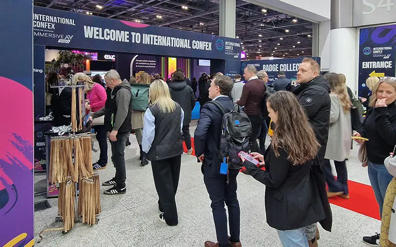 People entering an event where there is good signage, manned registration desks and self-service Printpods