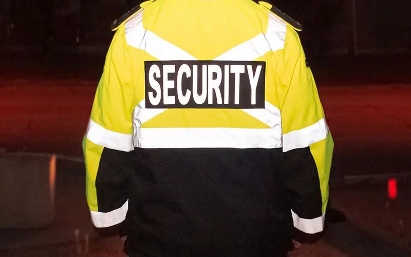 Person wearing a high-vis jacket with SECURITY written across the back