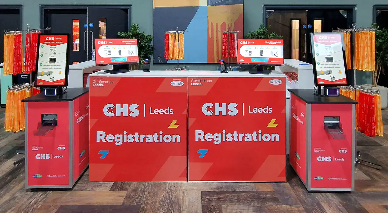 Registration desks and printPods at entrance to CHS Leeds